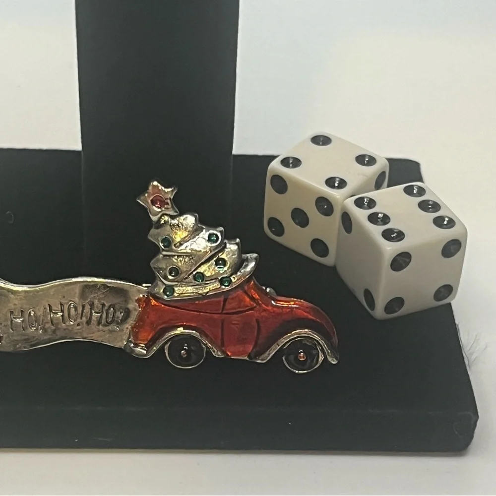 Vintage Christmas brooch, metal and enamel. There’s a dark spot on the Ho Ho Ho